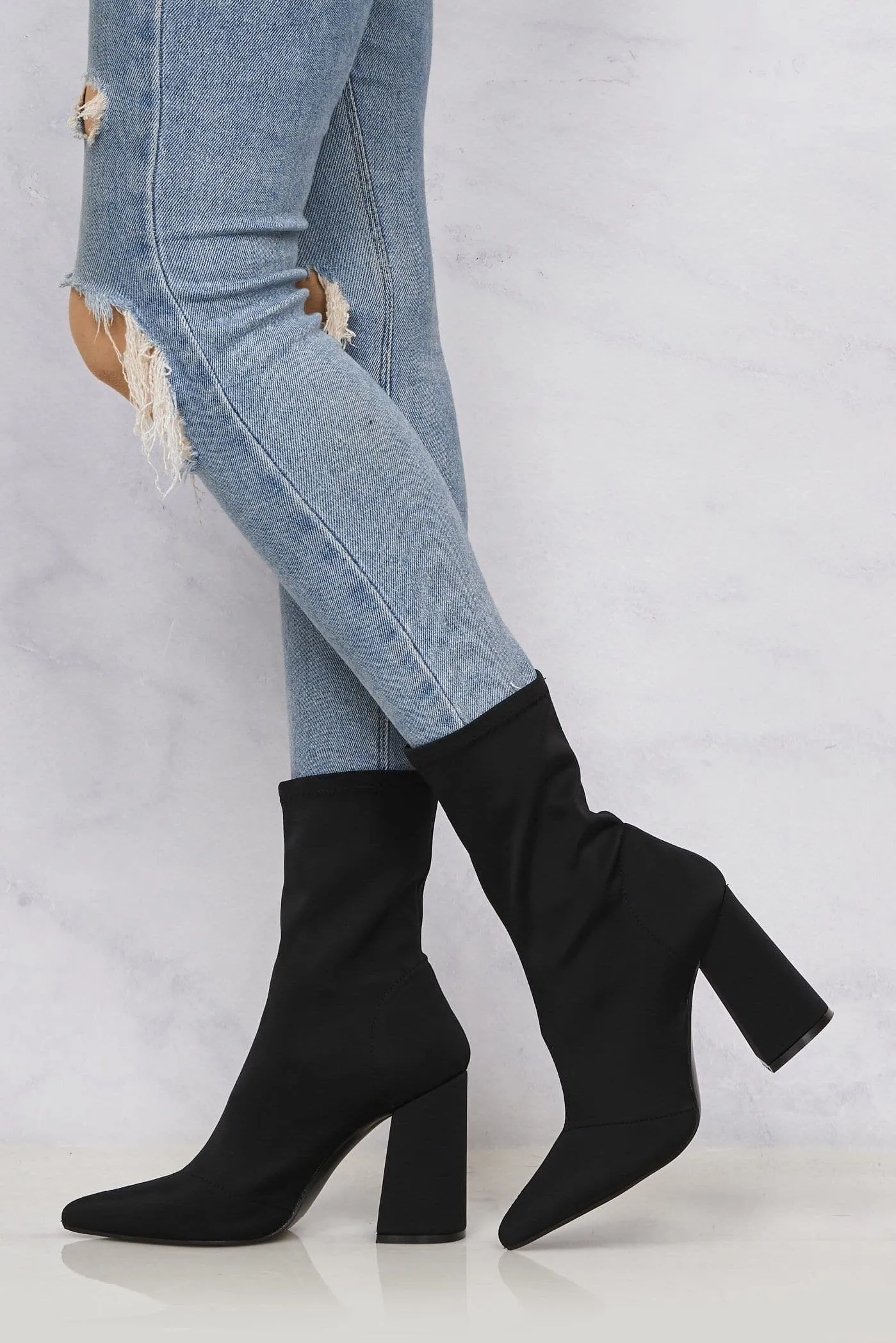 Everly Pointed Toe Flare Heel Calf Boot in Black Lycra